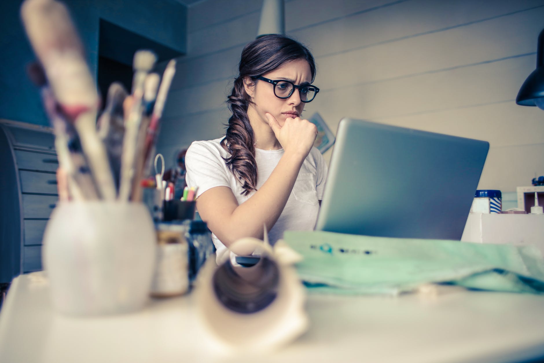 a concerned woman looking at her laptop