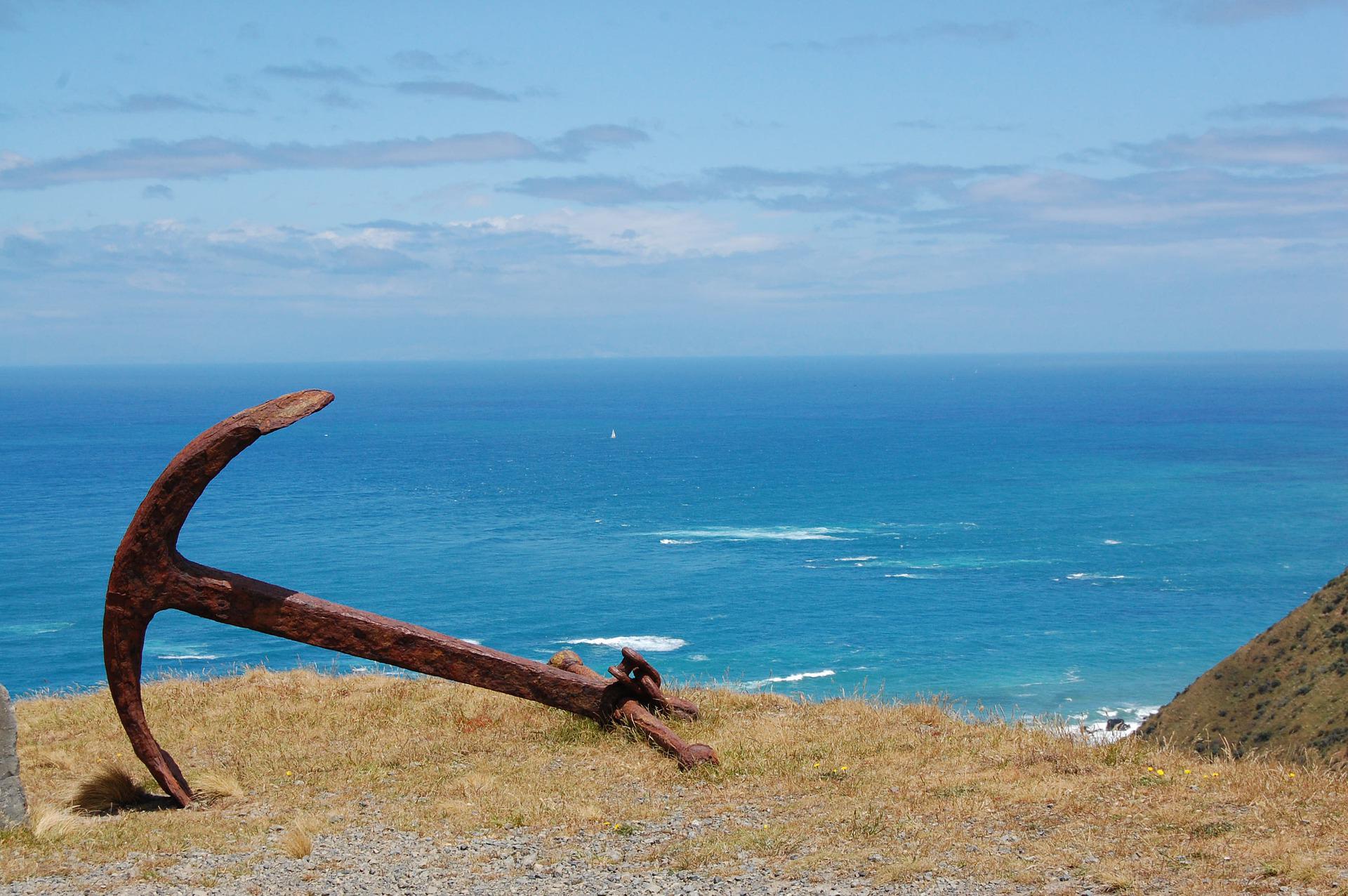 an anchor on a cliff overlooking the sea