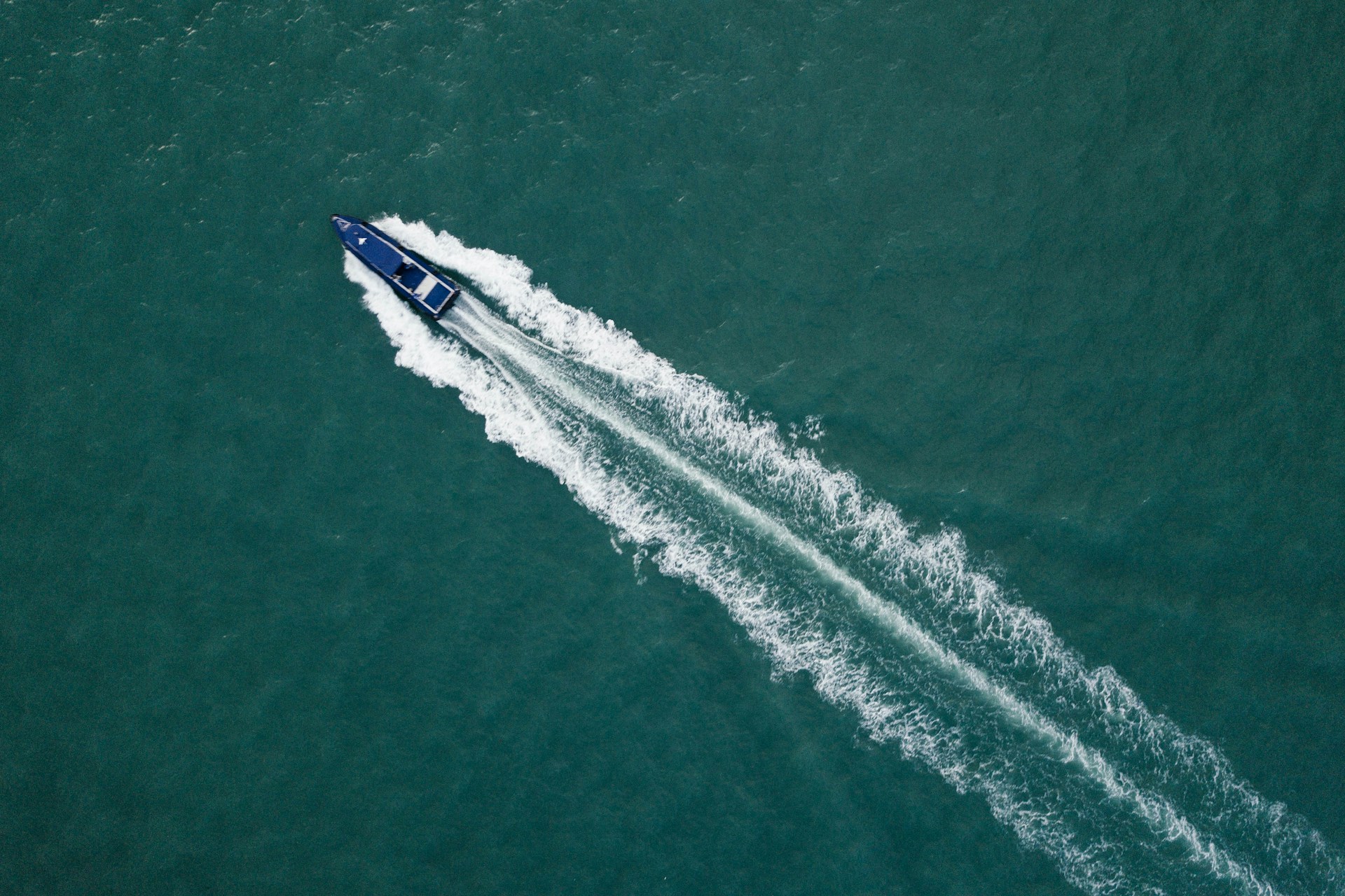 aerial view of a speed boat and its wake