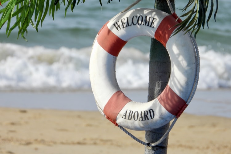 a life buoy on a palm tree with the words 'welcome aboard' on it