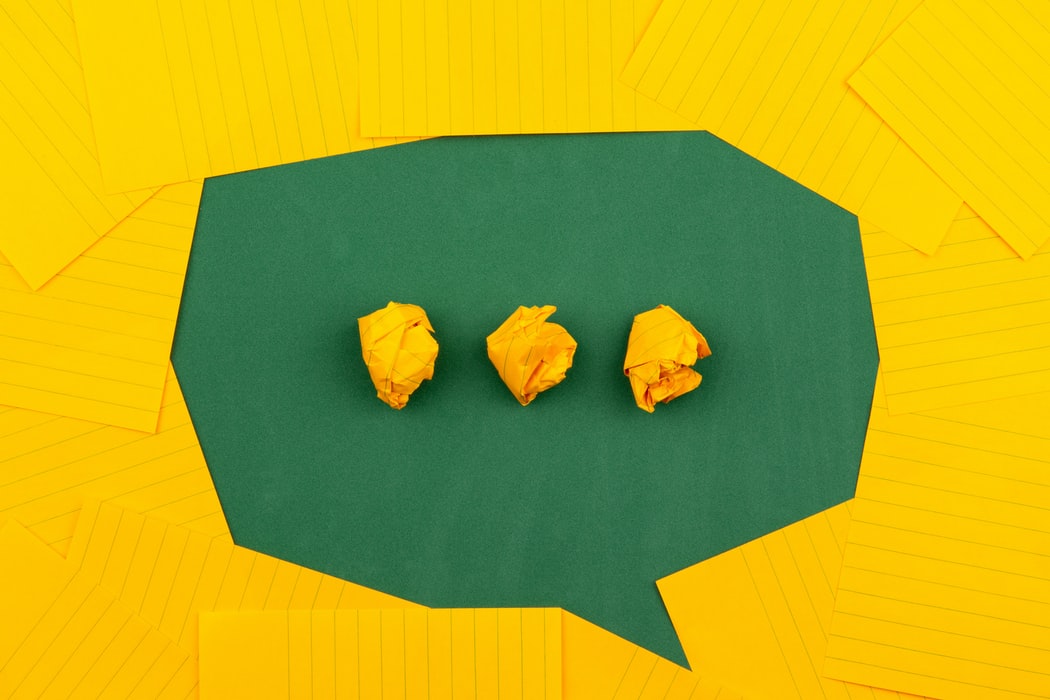 a yellow and green paper speech bubble 