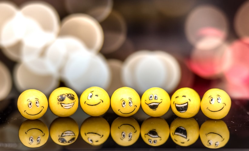 yellow balls with faces showing different expressions