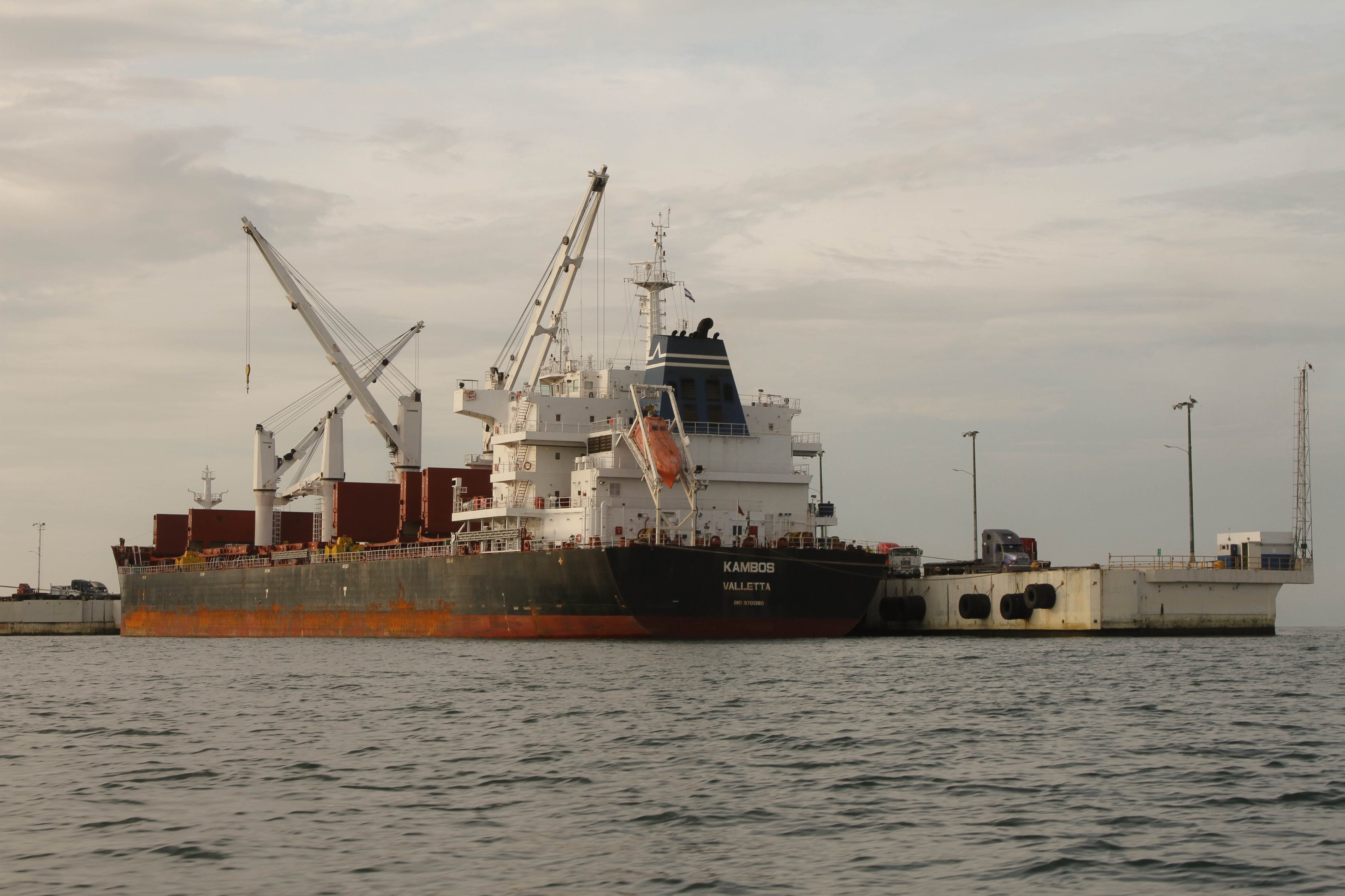 a rusty bulk carrier in port