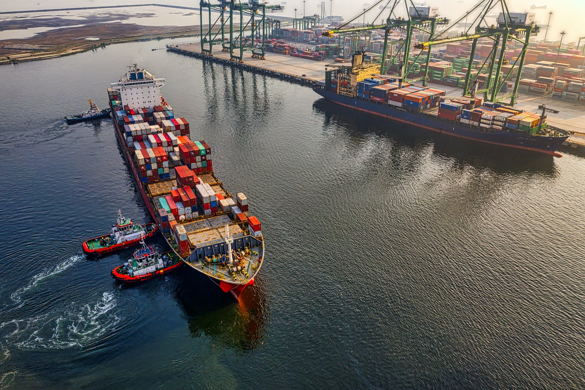 container ships and tugboats in a port