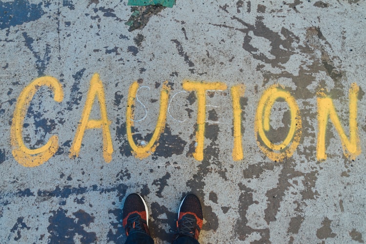 the word caution spray painted on the ground