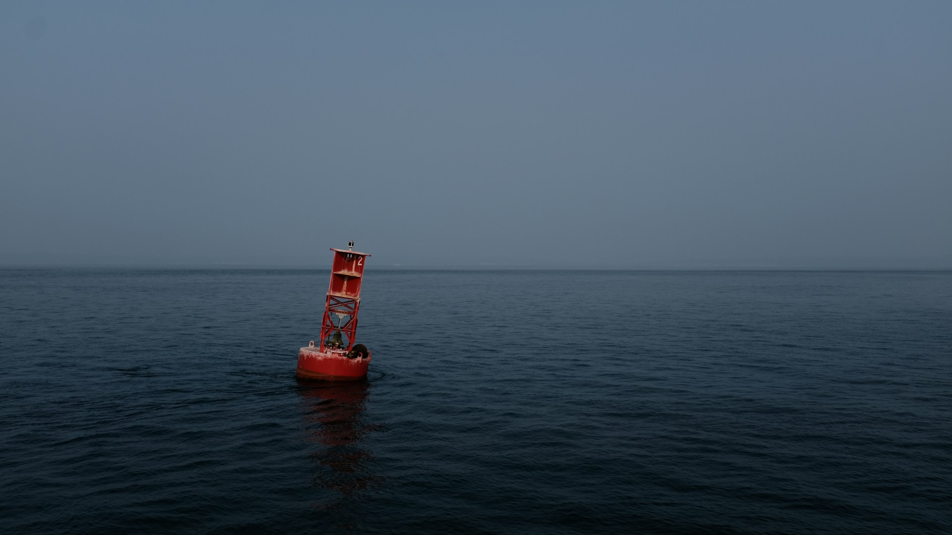 a buoy at sea under a gloomy sky