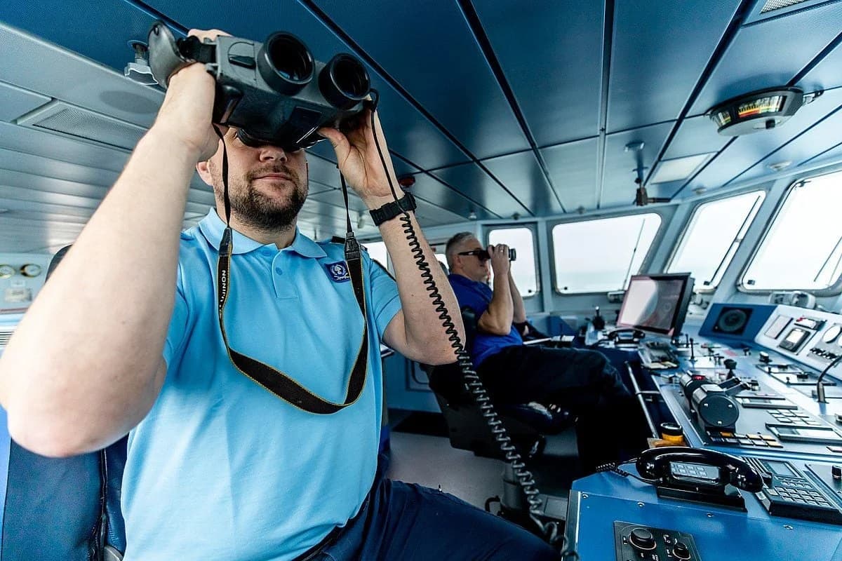 seafarer looking through binnoculars 