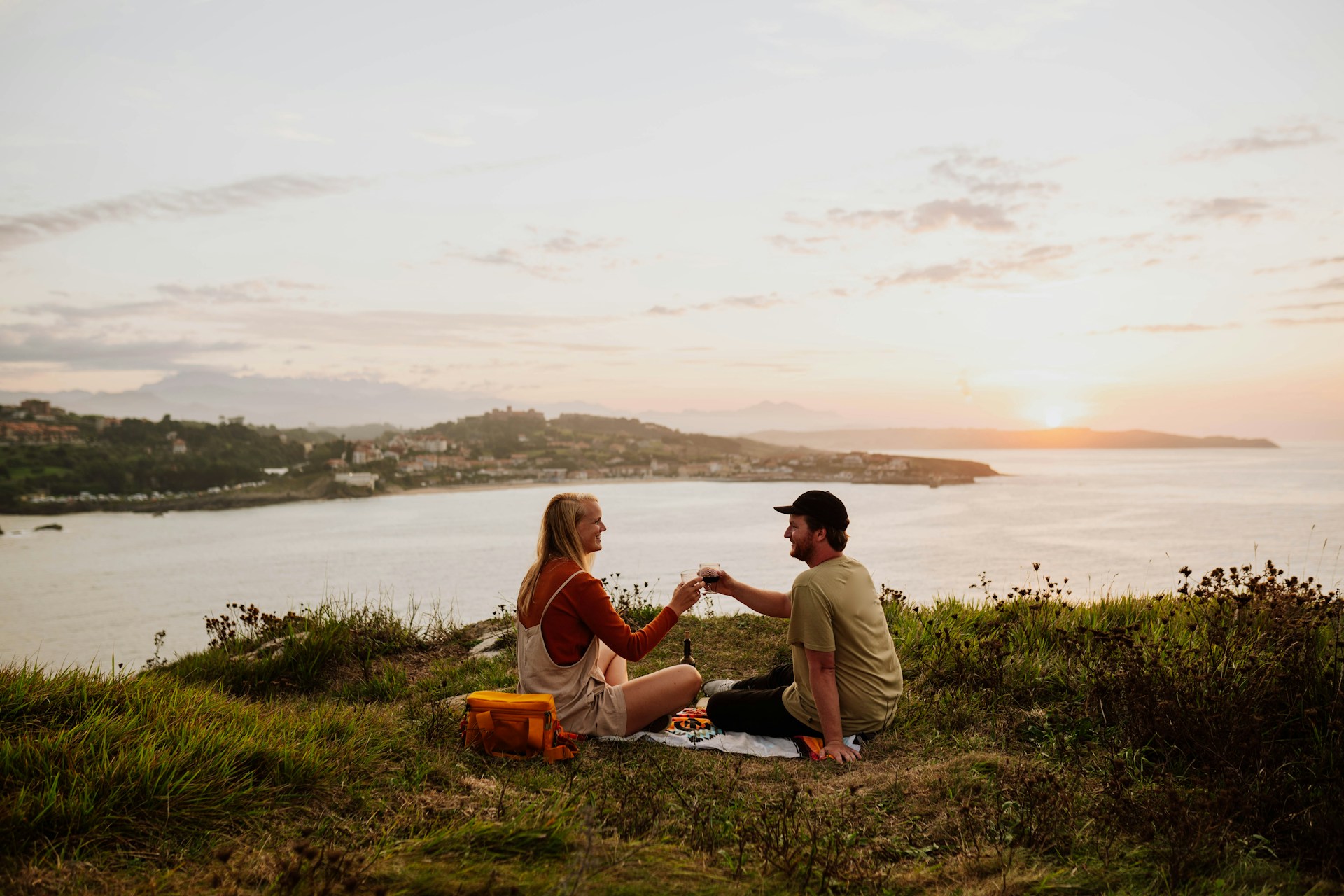 a couple having a romantic picnic overlooking the sea