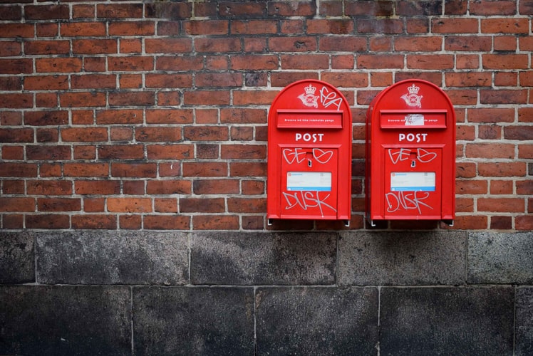 red mailboxes mounted on a wall