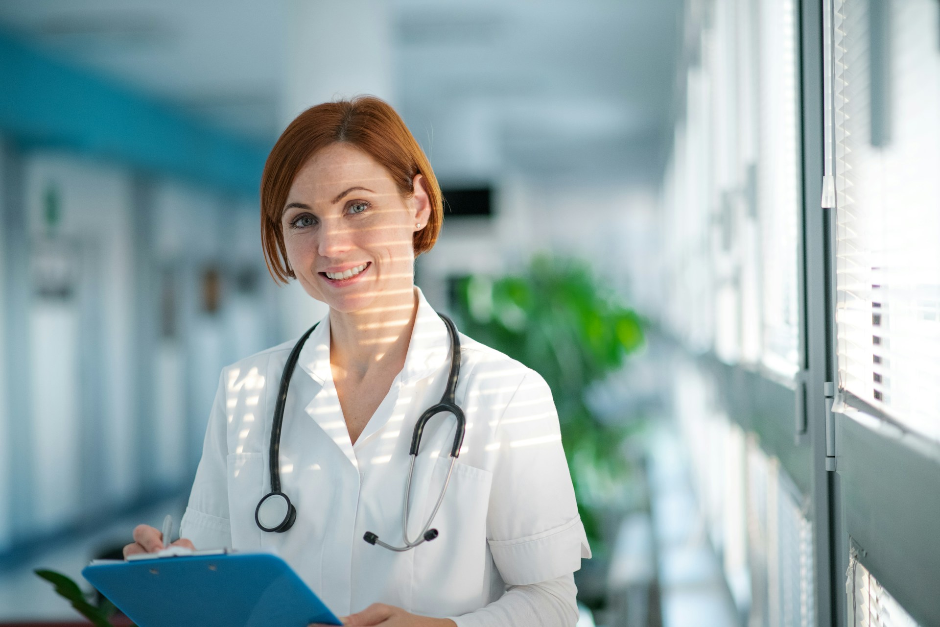 A smiling female doctor in clean white scrubs