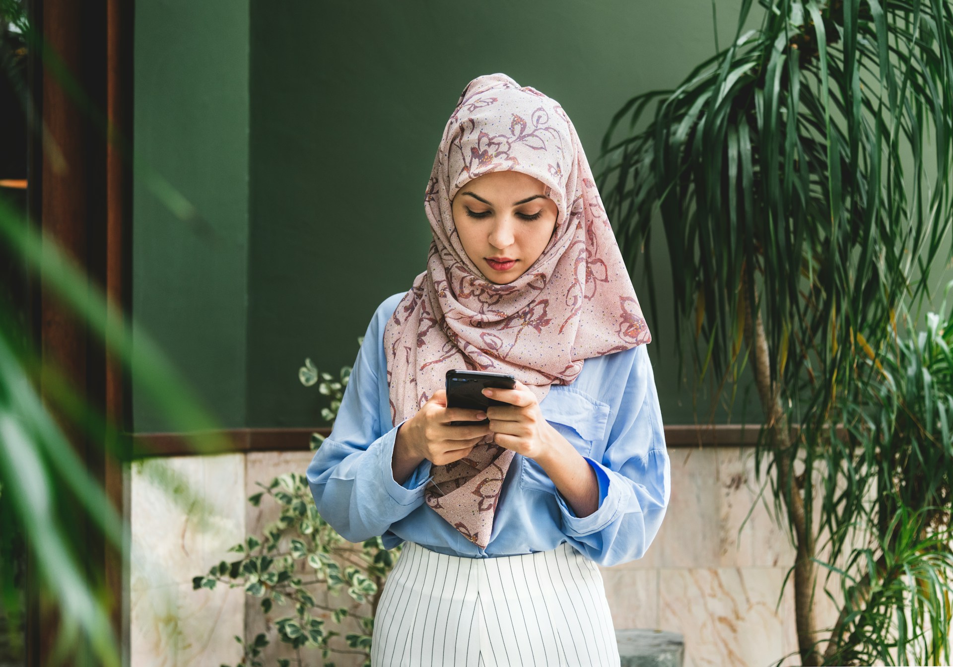 a serious looking woman looking at her phone