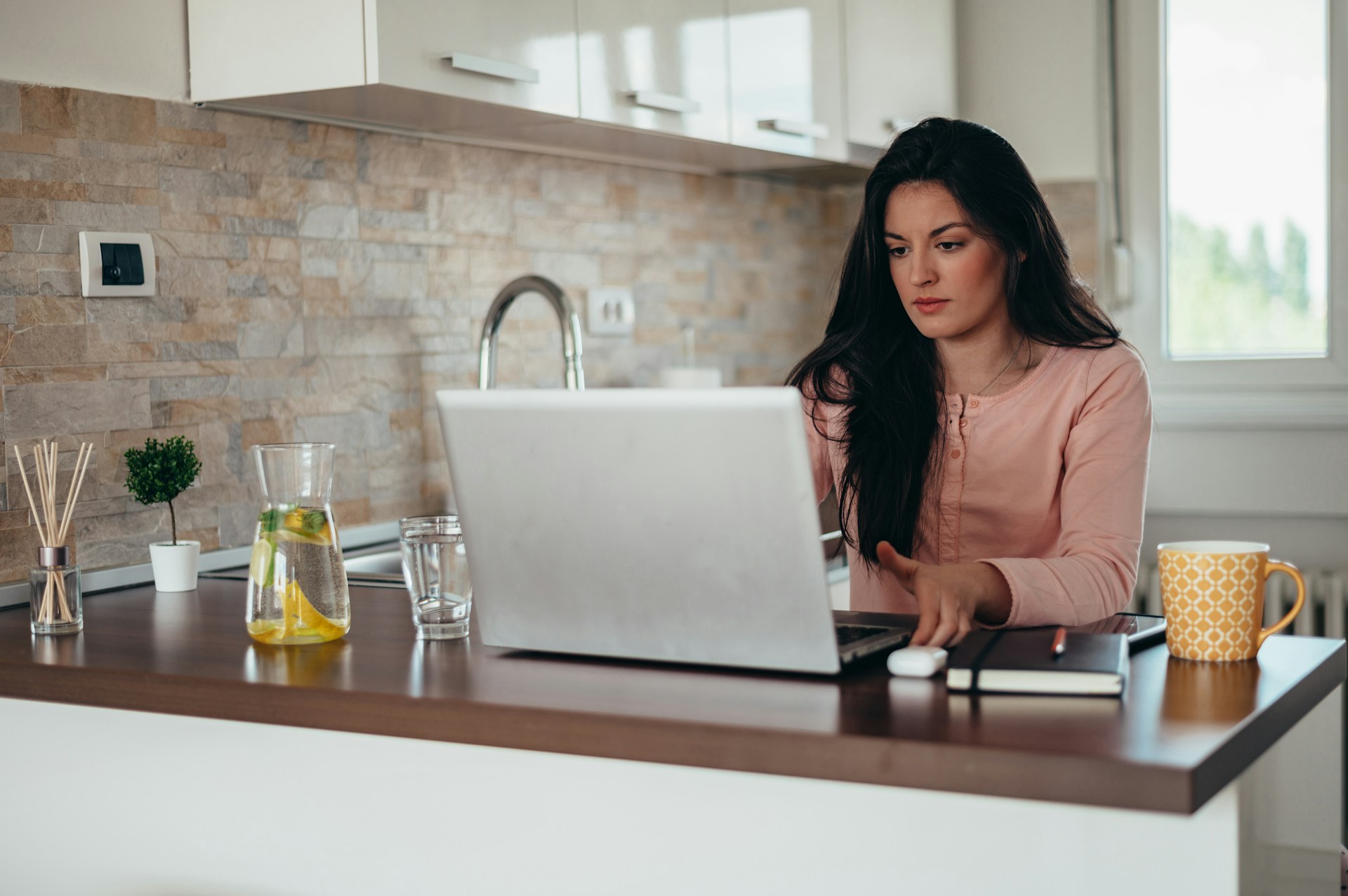 a woman working in her kitchen and looking a little concerned