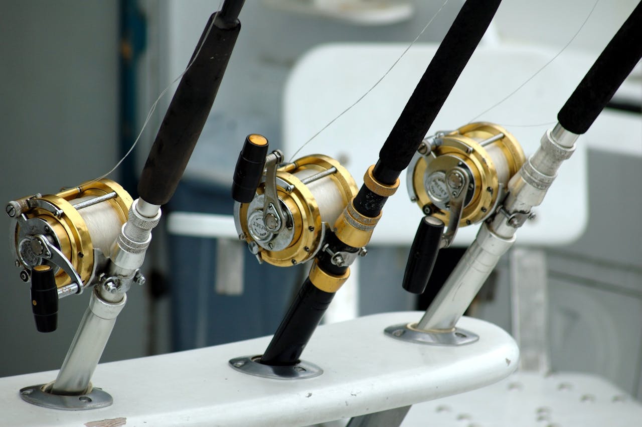 fishing lines and reels on the side of a boat