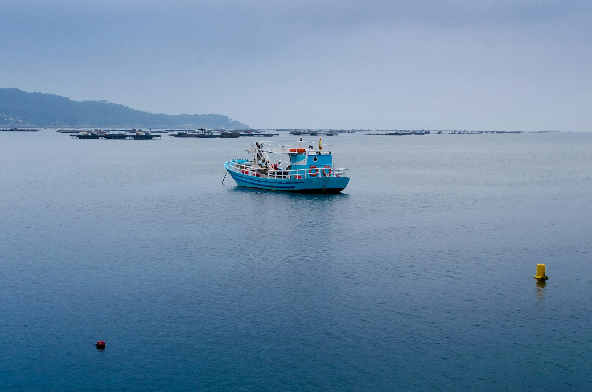 a small blue fishing boat