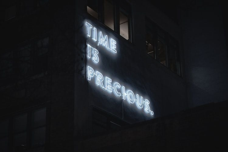 neon sign saying time is precious