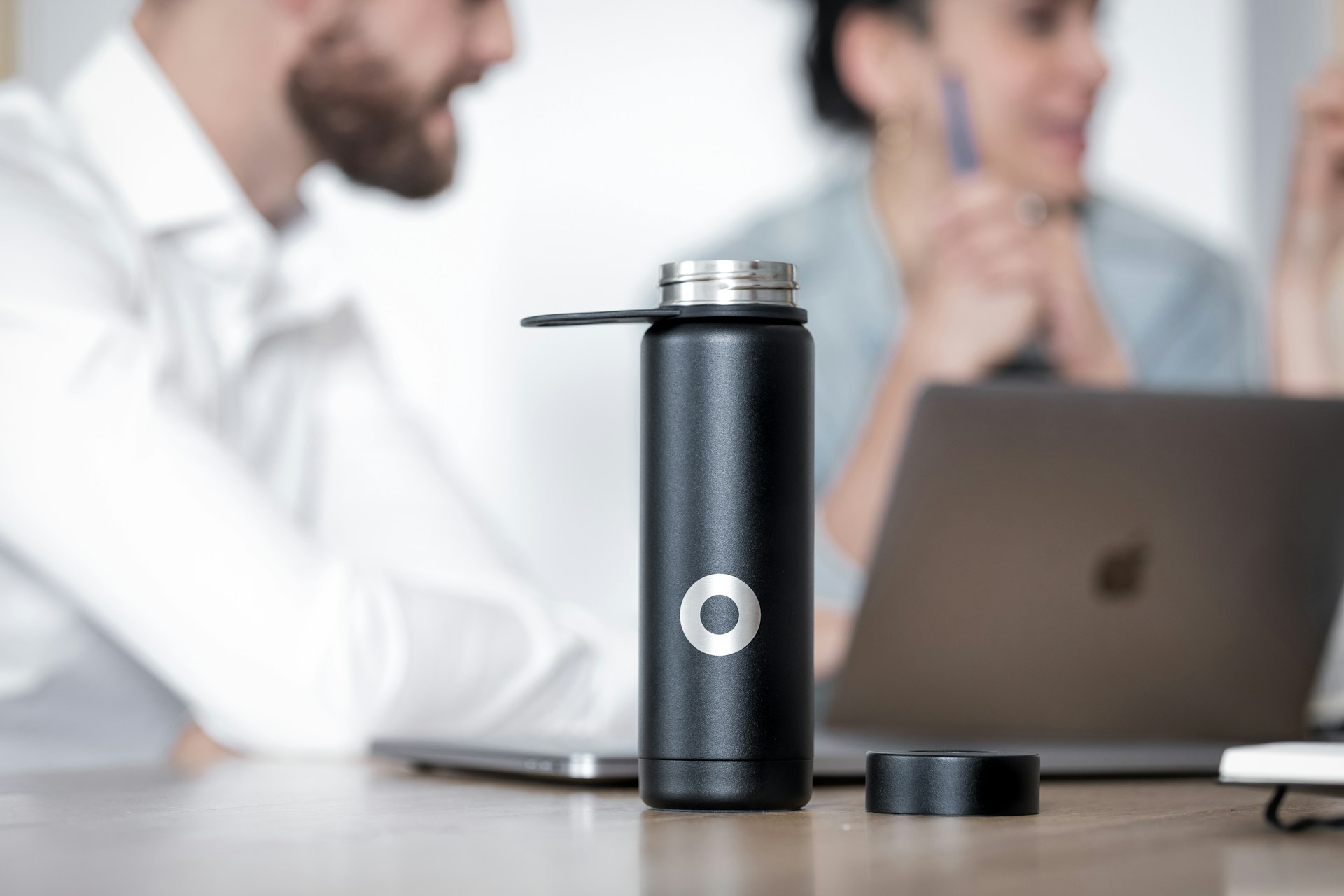 a water bottle on a man's desk