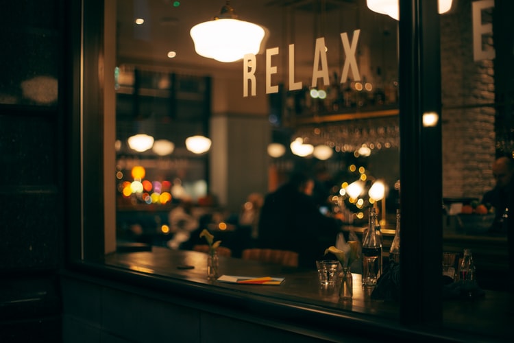 a bistro with the word 'relax' in its window