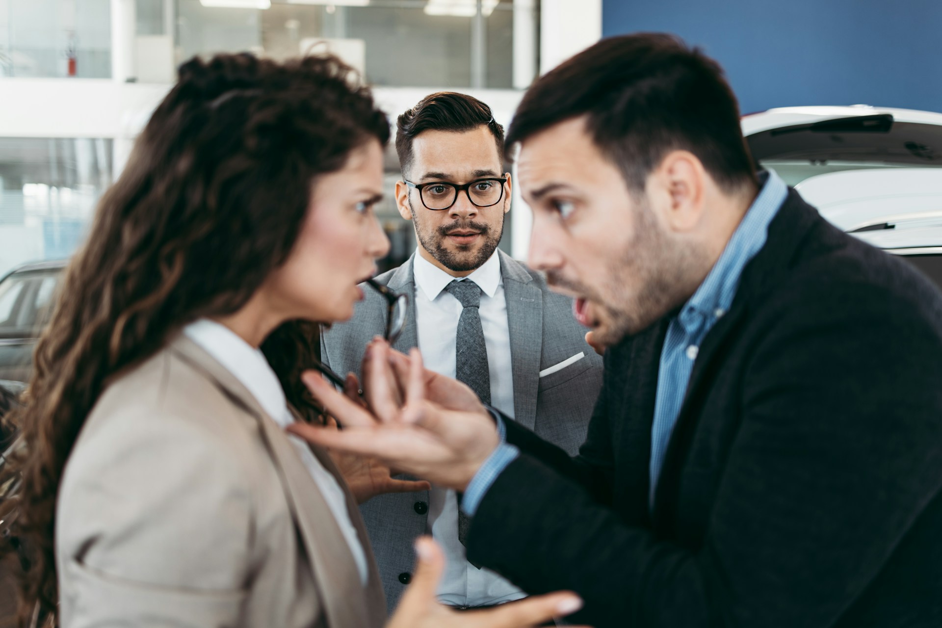 two coworkers arguing while another looks on