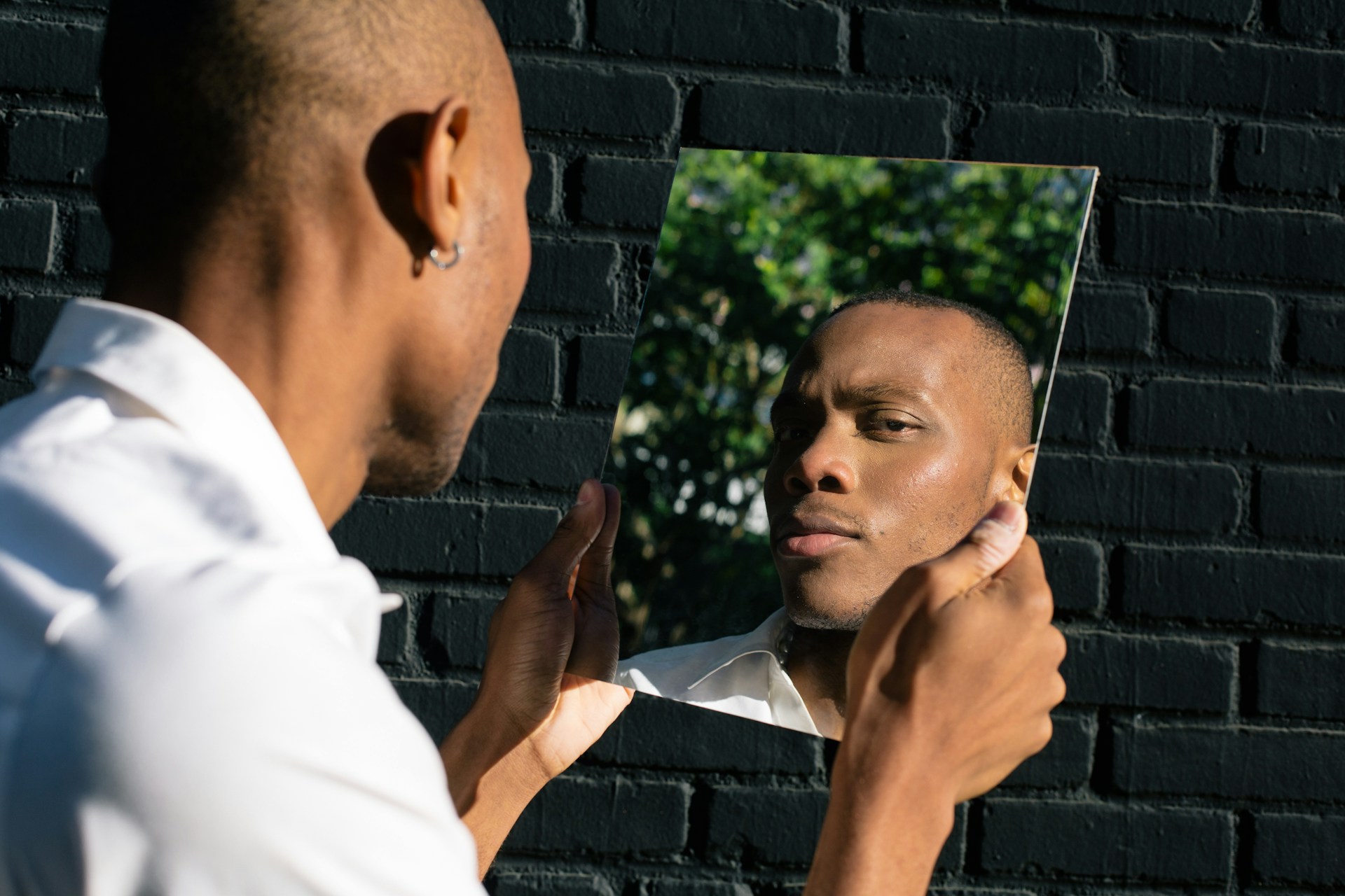 a man looking into a mirror at himself