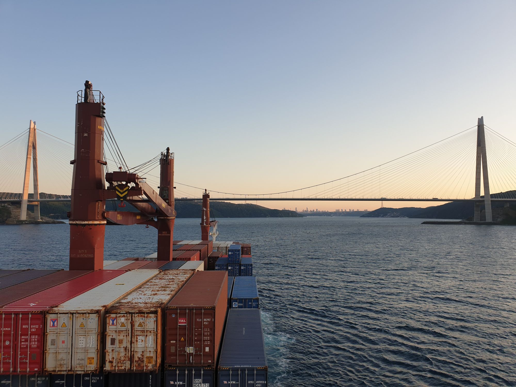 container ship sailing towards bridge