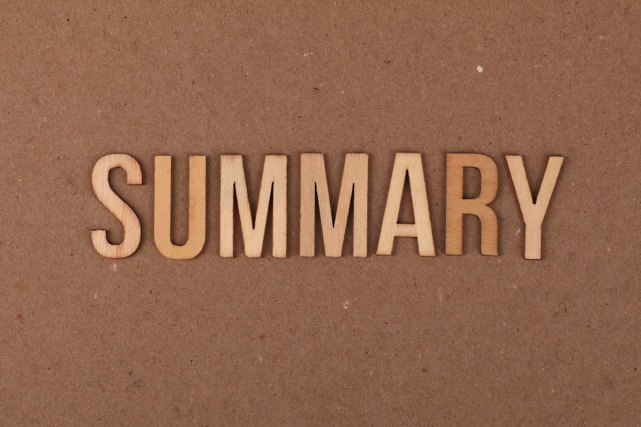 the word summary spelt out in wood pieces
