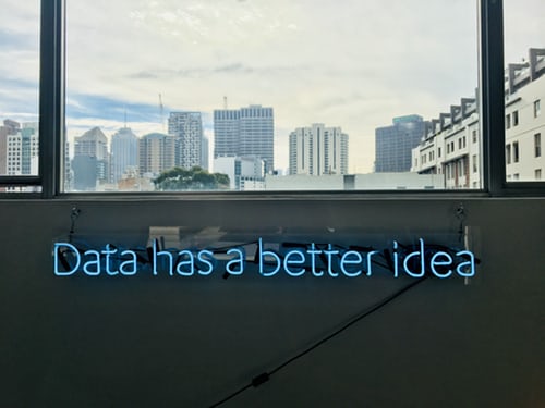 a neon sign in an office saying 'data has a better idea'