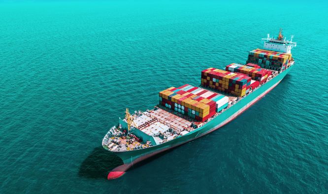 a cargo ship sailing on a turquoise sea