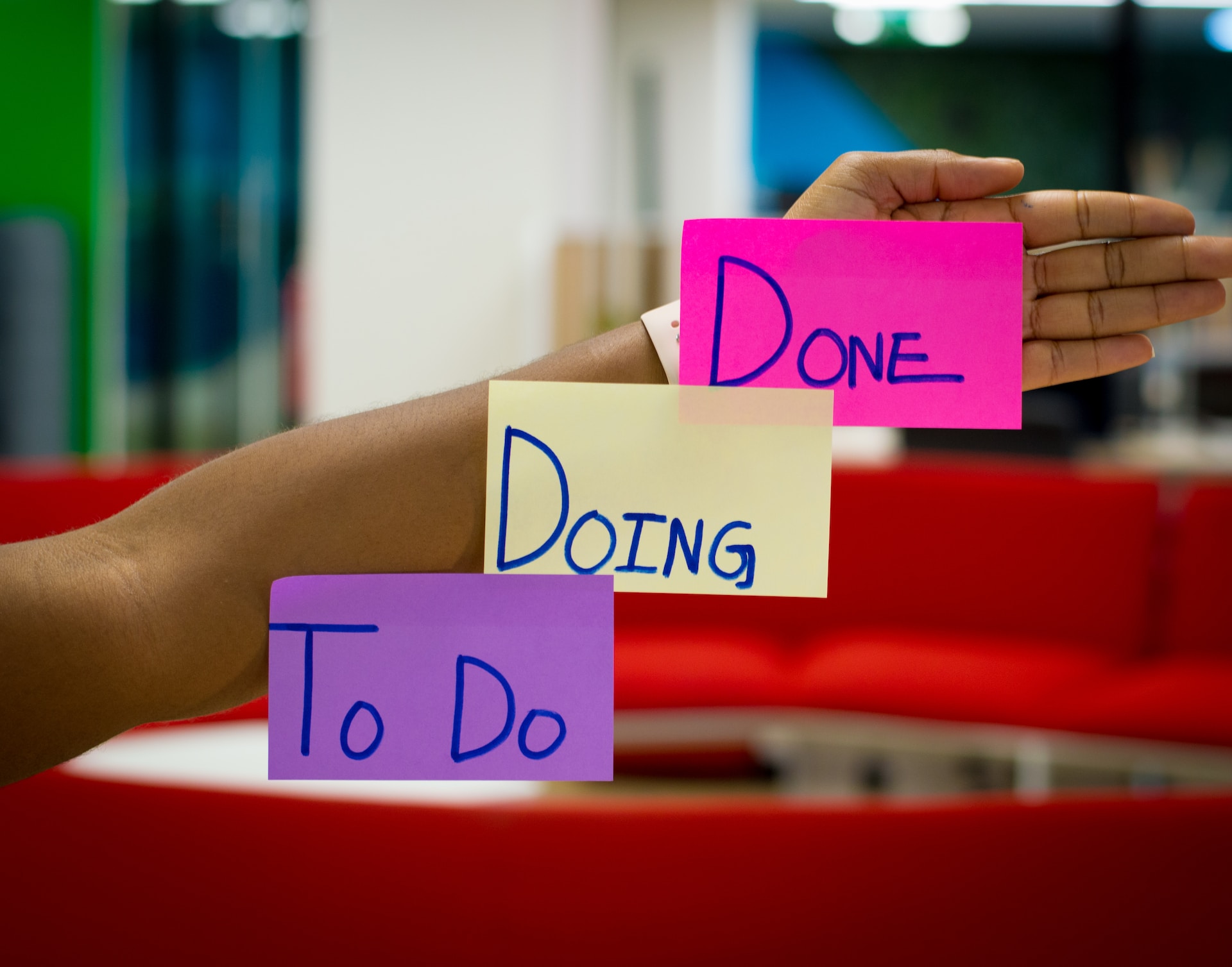 Post it notes stuck on an arm saying 'to-do, doing and done'