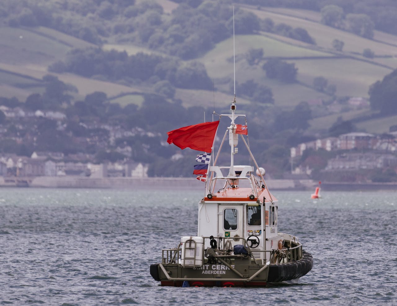 a small watercraft flying various flags