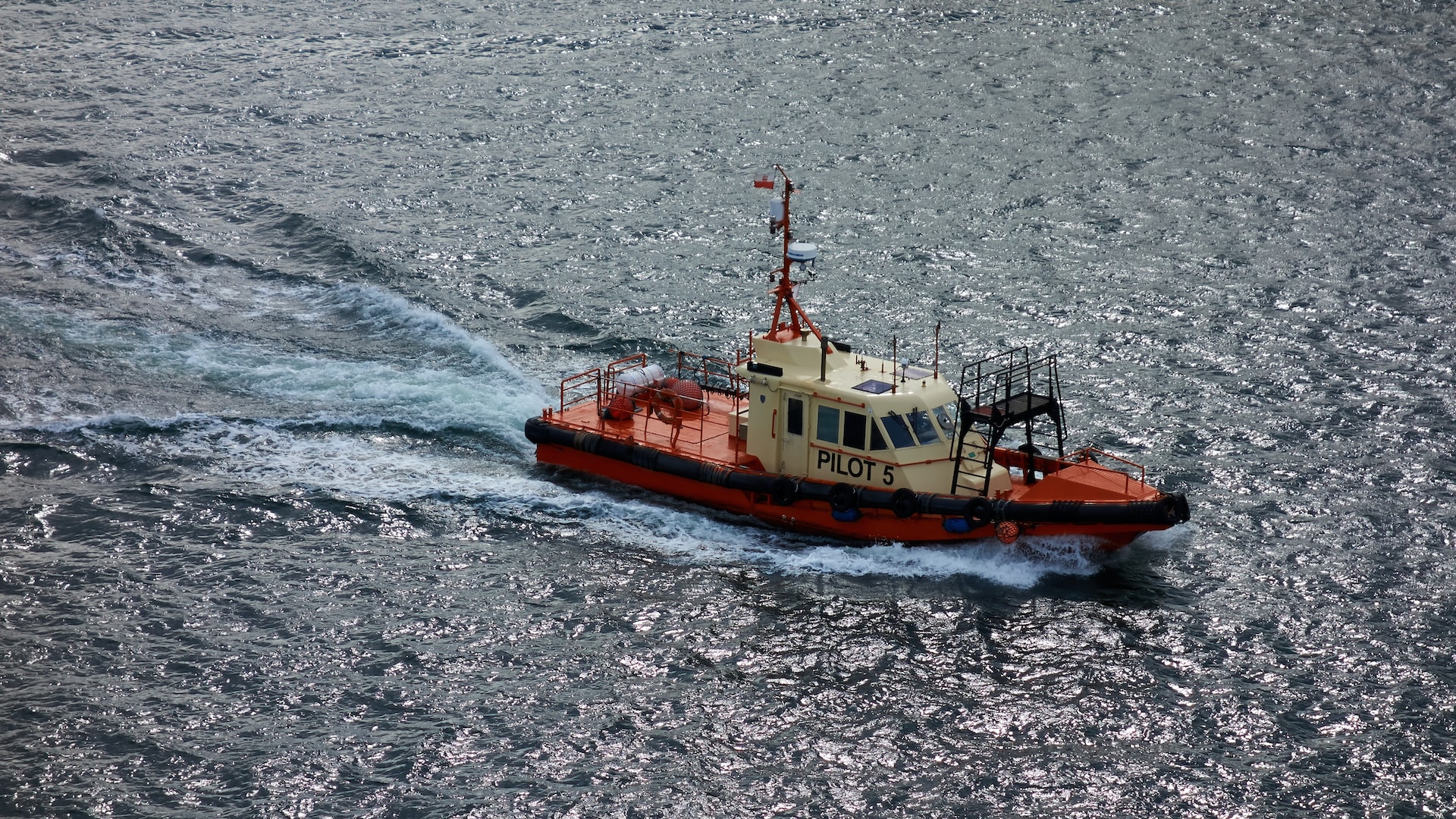 a red and white pilot boat