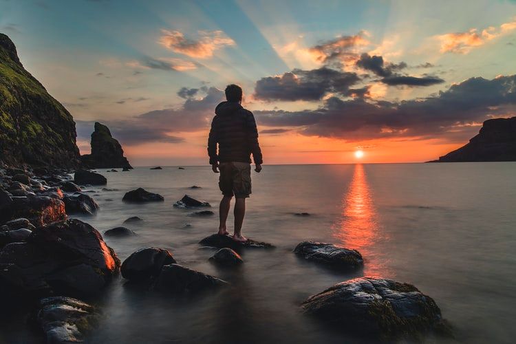 man looking at ocean