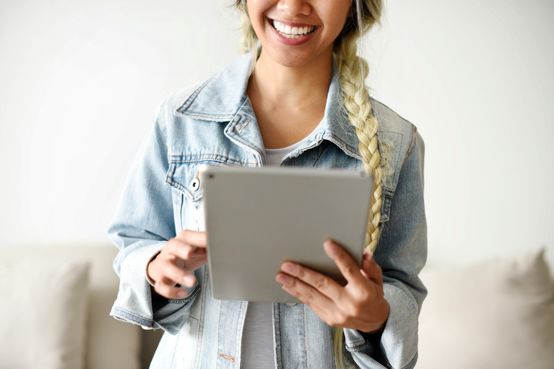 smiling Filipina woman holding iPad