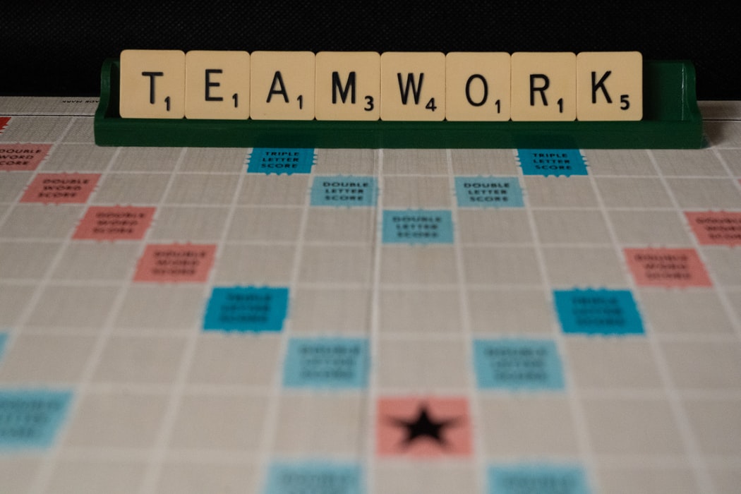 the word 'teamwork' spelt out in Scrabble tiles