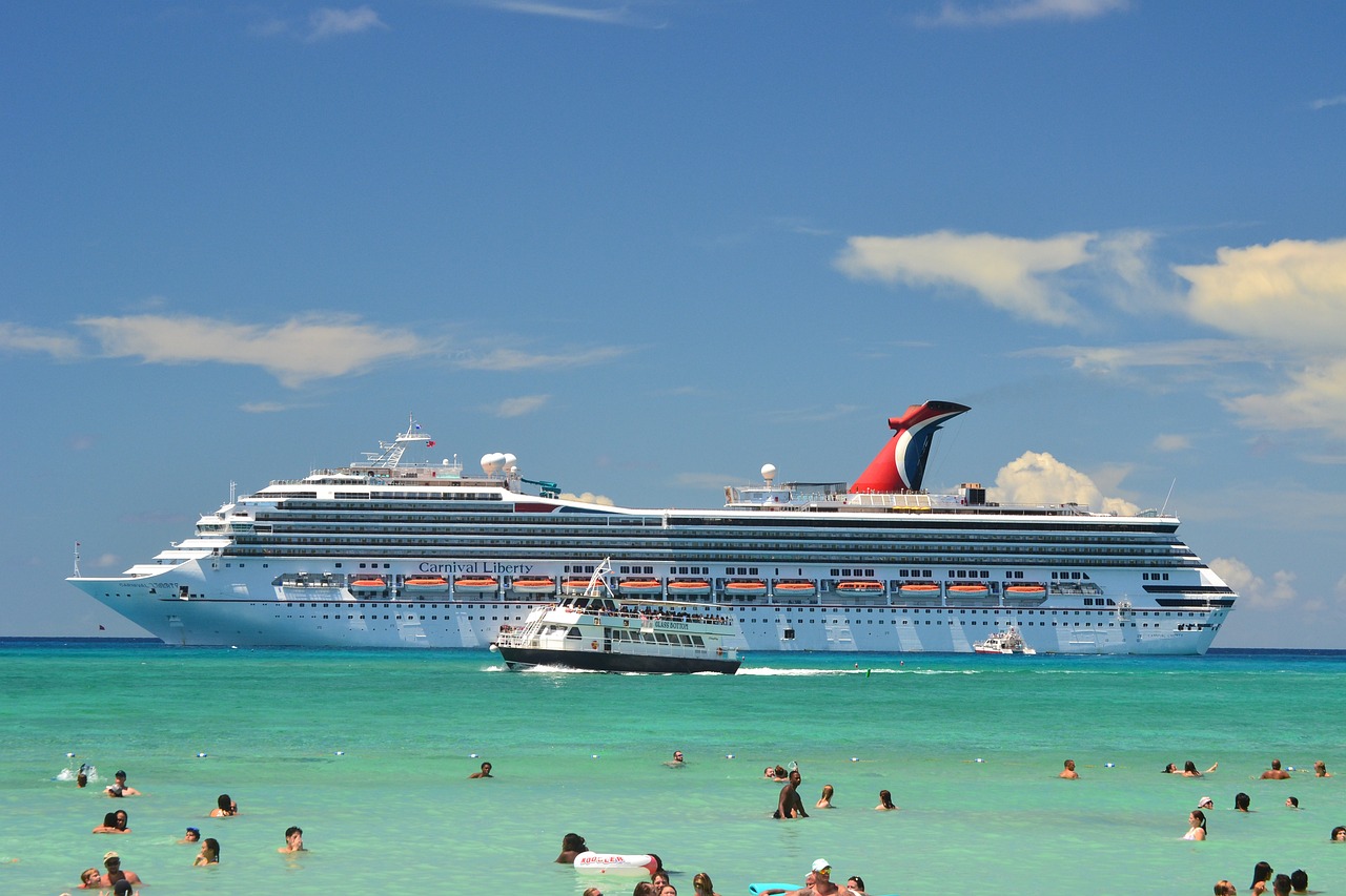 a Carnival cruise ship moored near a beach